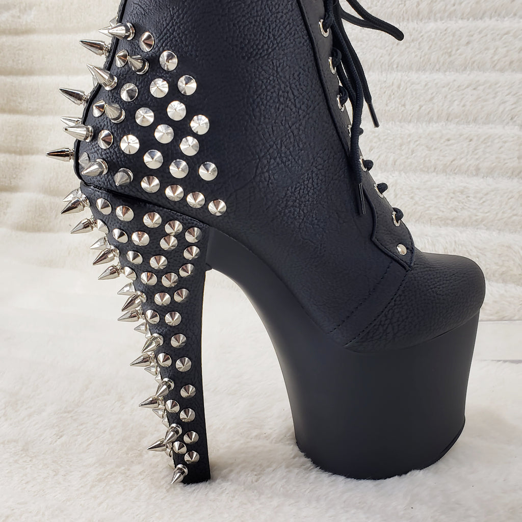 Premium Photo | A black shoe with spikes on it and the bottom of the heel.